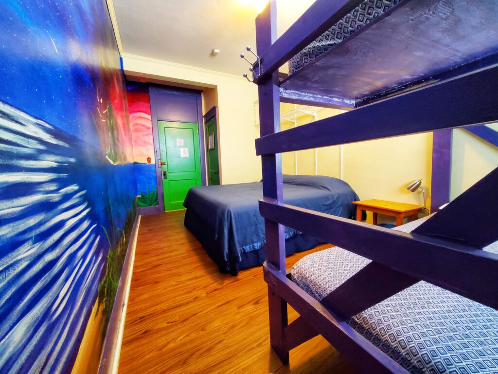 Voyage room, room 2, showing a partial view of the bunk and king bed.