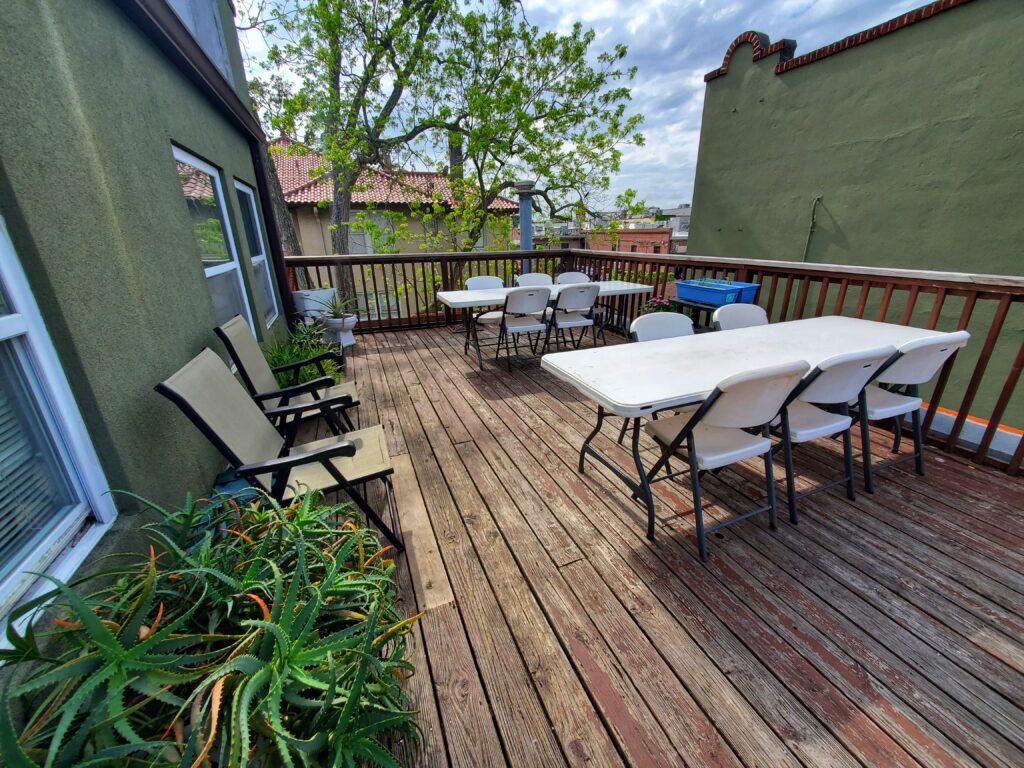 photo of patio showing deck seating and tables, and plants