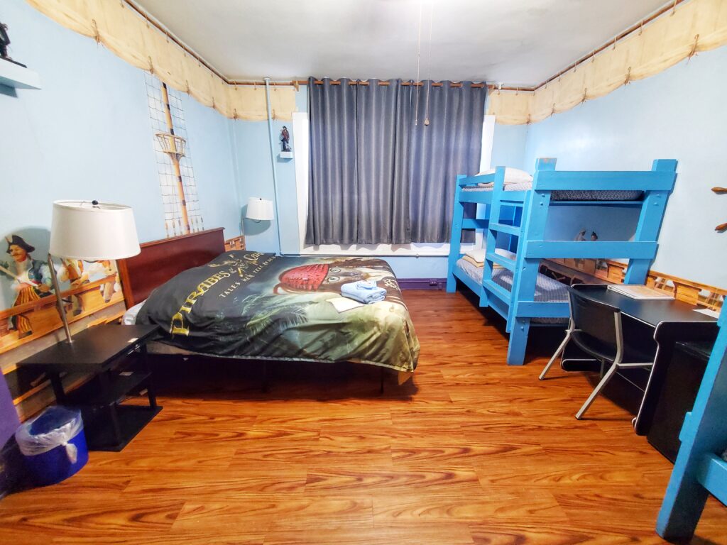 Room 10, Pirate Room, showing the king bed and bunk bed.